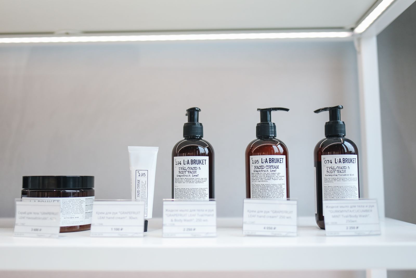 Salon retail shelf stocked with labelled products and price cards